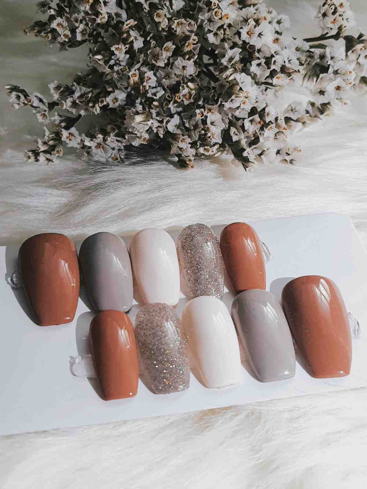 Nail art featuring floral patterns and gems